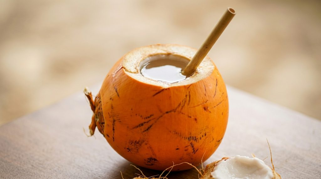 Fresh king coconut with a straw